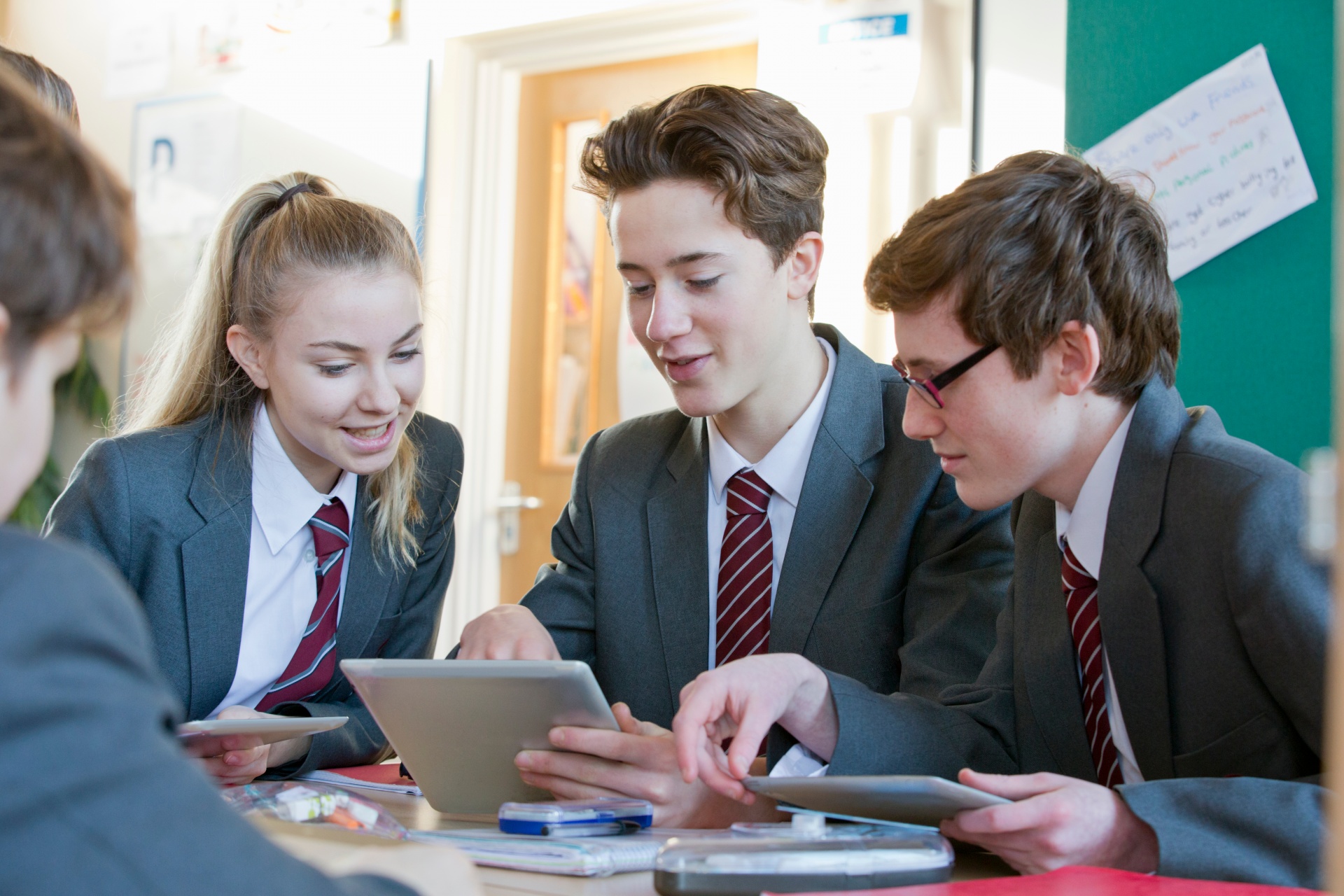 Pupils working together on a tablet